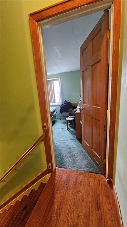 hall with wood finished floors and baseboards
