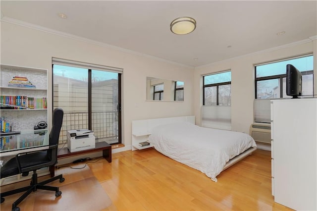 bedroom with light wood-style floors, access to outside, and crown molding