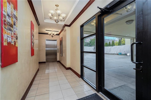 corridor featuring a notable chandelier, baseboards, ornamental molding, a raised ceiling, and elevator