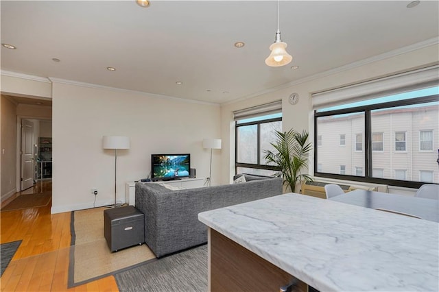 interior space featuring recessed lighting, baseboards, crown molding, and light wood finished floors