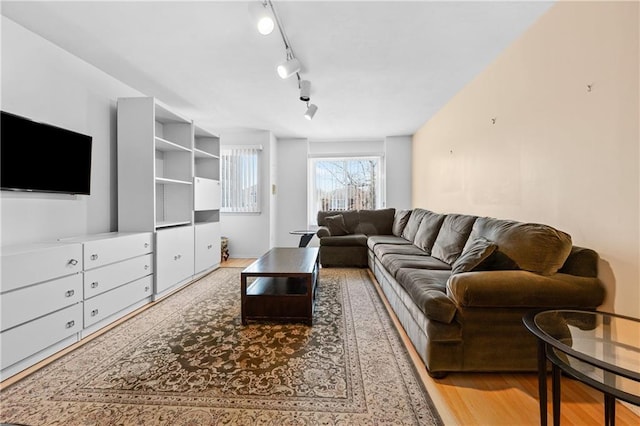 living area featuring track lighting and wood finished floors