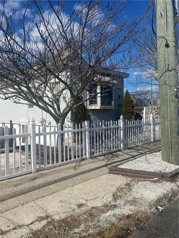 view of gate with a fenced front yard