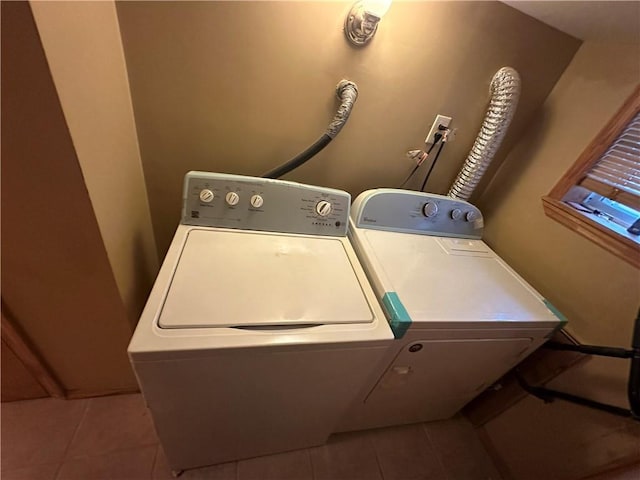 laundry area featuring laundry area, washer and clothes dryer, and tile patterned floors