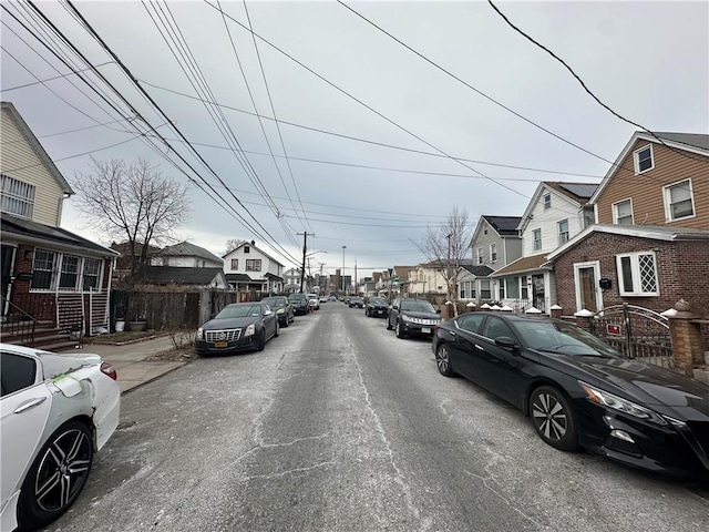 view of street featuring sidewalks, street lighting, and a residential view