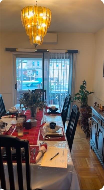 dining room with a wall mounted air conditioner and an inviting chandelier