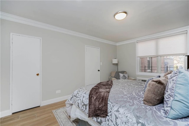 bedroom featuring light wood-style floors, baseboards, and ornamental molding