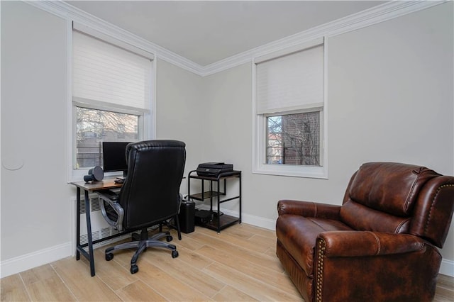 office space with light wood finished floors, baseboards, and crown molding