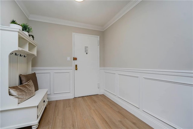 mudroom featuring light wood-style flooring, ornamental molding, and wainscoting