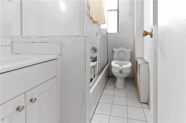 bathroom with tile patterned flooring, bathtub / shower combination, vanity, and toilet