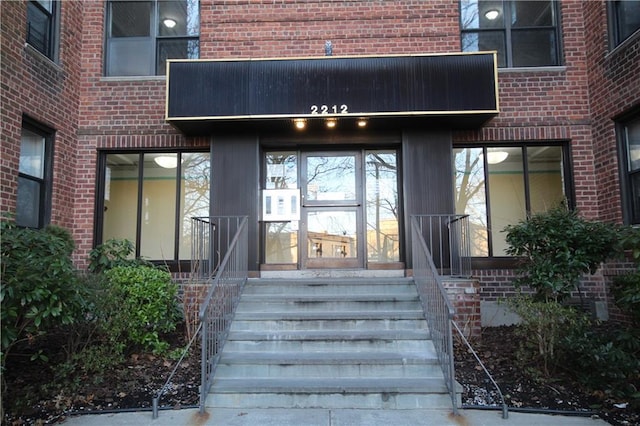 property entrance featuring brick siding