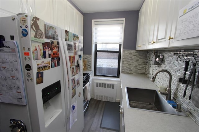 2212 Plumb 1st St Unit 1C, Brooklyn, NY 11229 - kitchen with white refrigerator with ice dispenser, radiator, tasteful backsplash, light countertops, and range