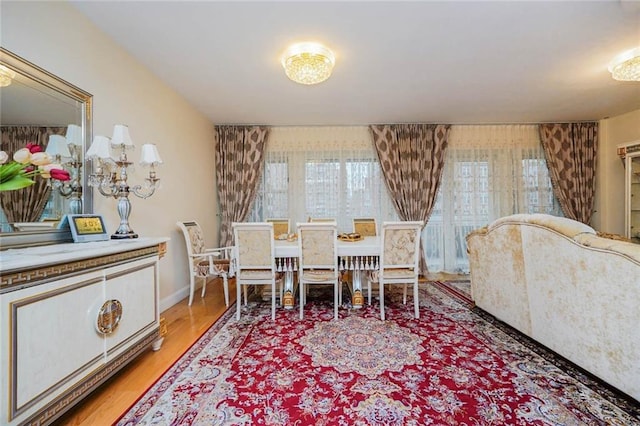 dining area featuring baseboards and light wood-style flooring