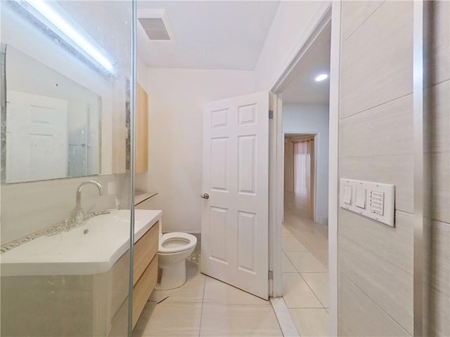 bathroom with toilet, tile patterned floors, visible vents, and vanity