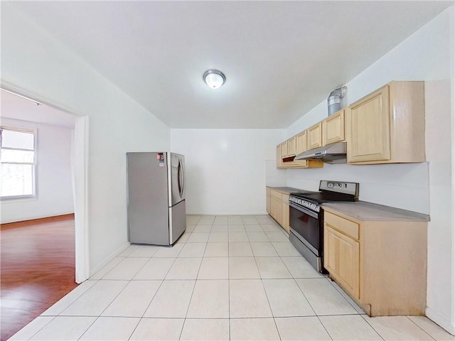 kitchen with black electric range, under cabinet range hood, light brown cabinets, and freestanding refrigerator