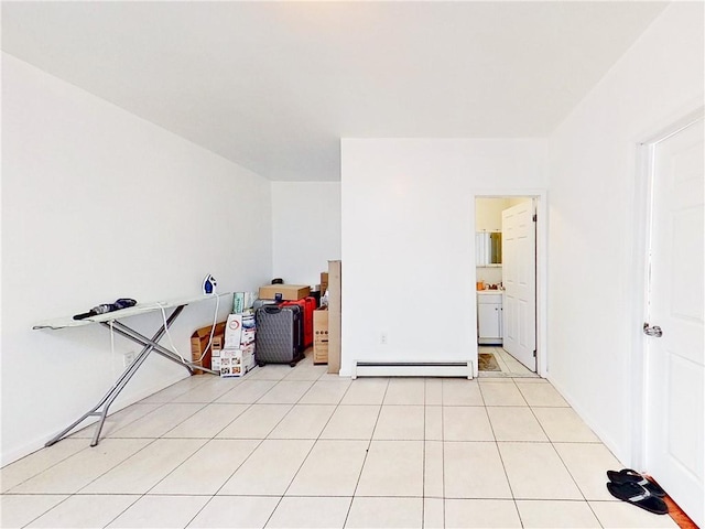 interior space featuring a baseboard heating unit and light tile patterned floors