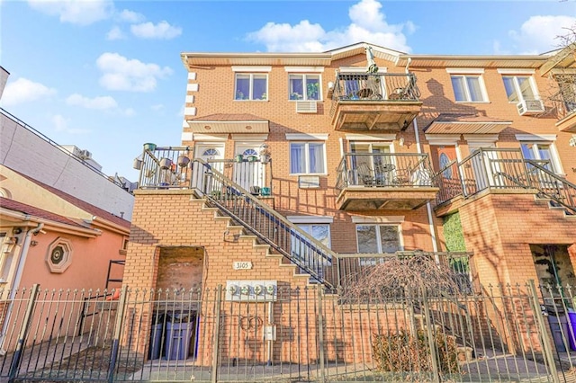 multi unit property featuring fence and brick siding