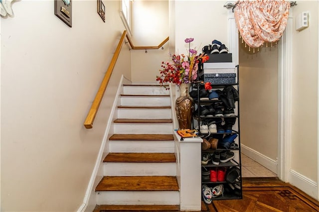 staircase with tile patterned floors and baseboards