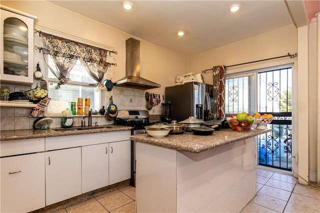 kitchen with a healthy amount of sunlight, stainless steel appliances, ventilation hood, and a sink