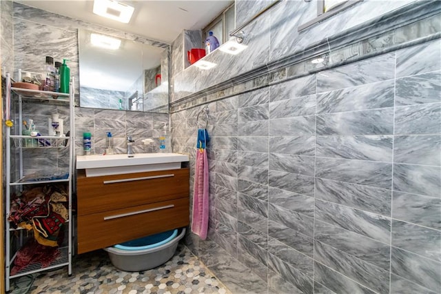 bathroom featuring tile walls and vanity