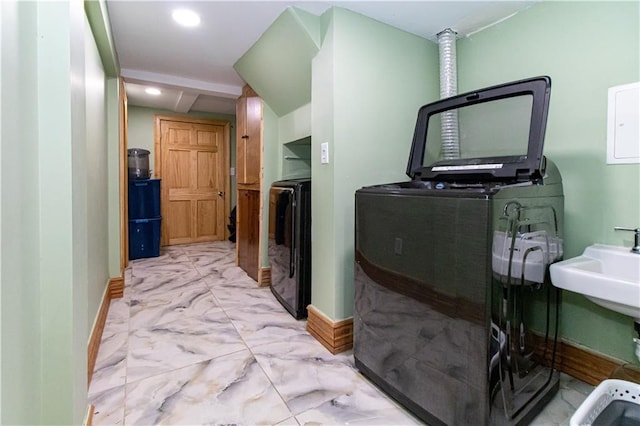 interior space with marble finish floor, baseboards, laundry area, and washer / clothes dryer