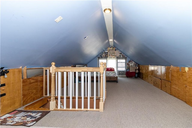 bonus room featuring carpet and vaulted ceiling