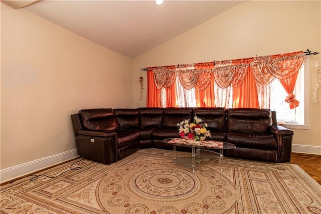 living room featuring lofted ceiling and baseboards