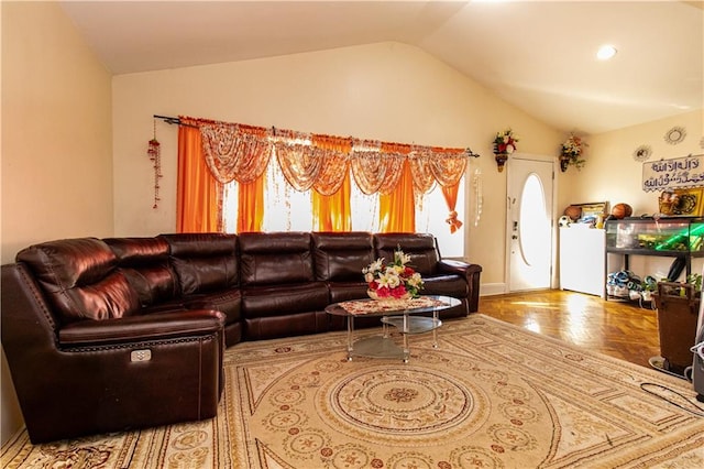 living area with a healthy amount of sunlight and vaulted ceiling