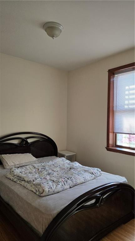 bedroom with wood finished floors