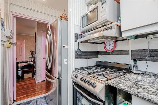 kitchen with appliances with stainless steel finishes, backsplash, and light stone counters