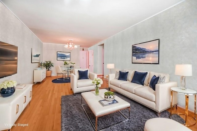 living area featuring light wood-style flooring and a notable chandelier