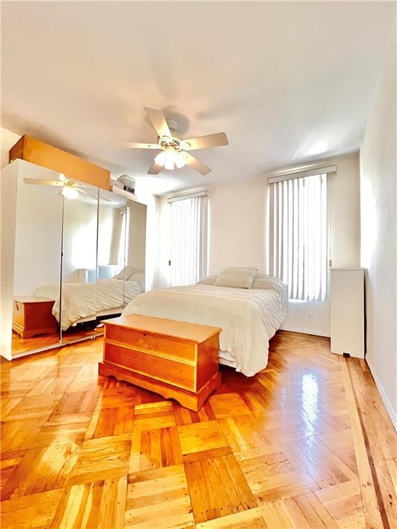 bedroom with ceiling fan and baseboards