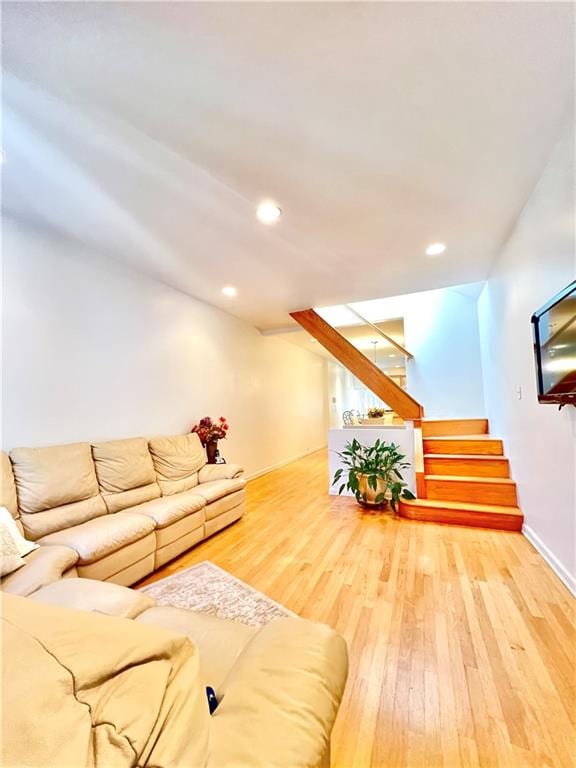 living room featuring stairs, wood finished floors, and recessed lighting