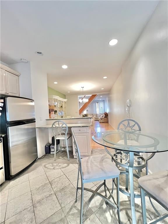 dining area with recessed lighting and light tile patterned flooring