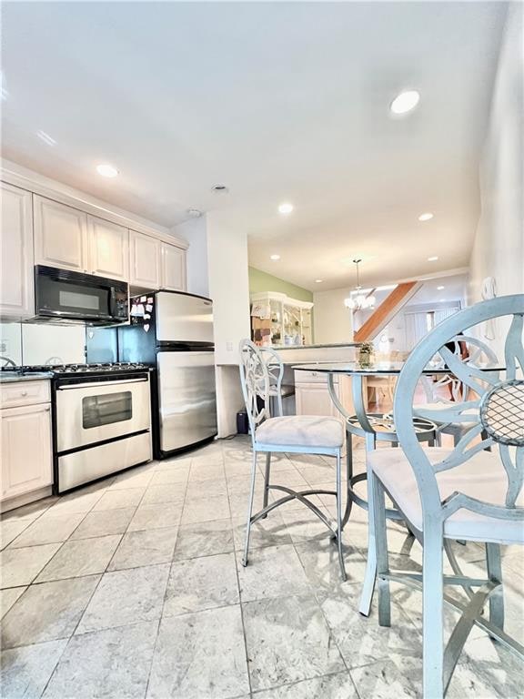 kitchen featuring appliances with stainless steel finishes, dark countertops, and recessed lighting