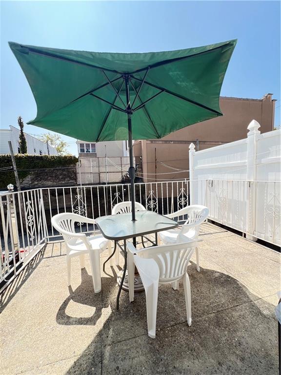 view of patio / terrace featuring a balcony and outdoor dining area