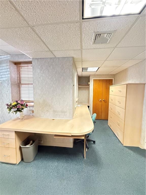 interior space with a paneled ceiling, carpet, and visible vents