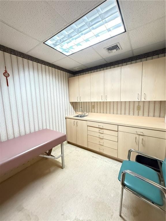 interior space with a paneled ceiling and visible vents