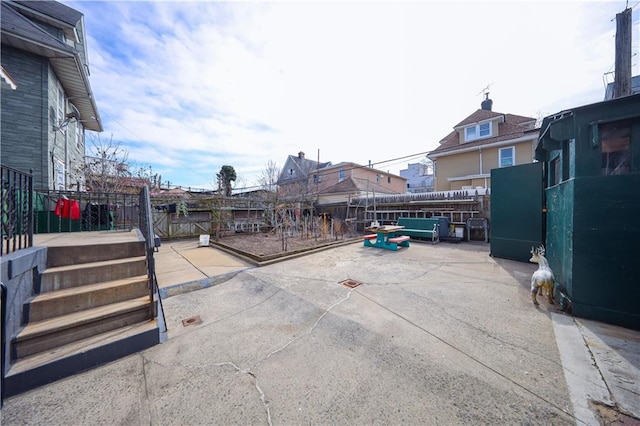 view of gate with a patio area and fence