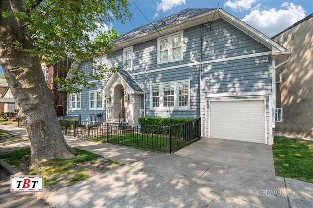 view of front of home with a fenced front yard, concrete driveway, and an attached garage