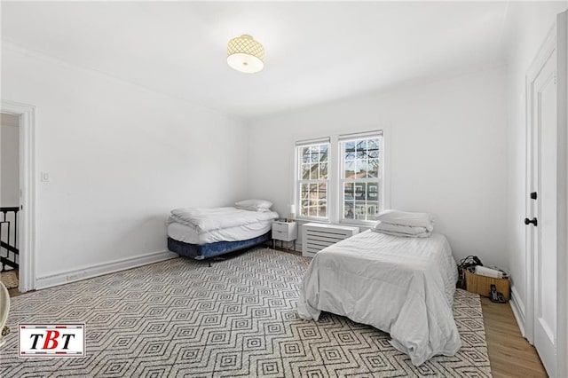 bedroom featuring light wood-style flooring and baseboards