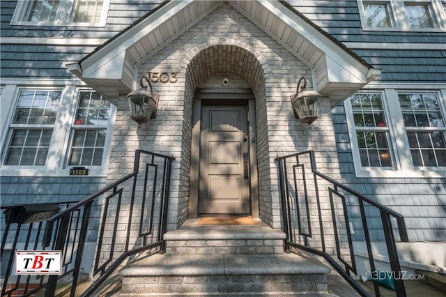 property entrance featuring brick siding