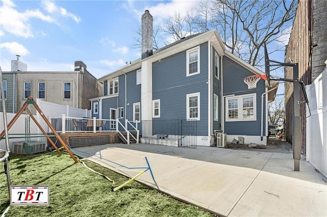 rear view of property featuring ac unit, a patio area, and fence