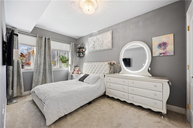 bedroom featuring baseboards and light colored carpet