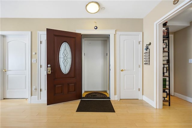 entrance foyer with light wood finished floors and baseboards