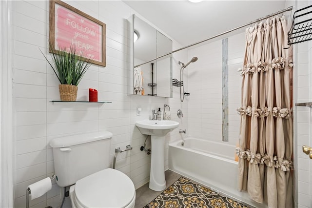 bathroom with shower / bath combo, tile walls, toilet, tile patterned flooring, and a sink