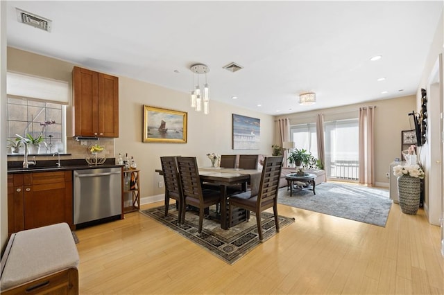 dining area featuring light wood finished floors, recessed lighting, visible vents, and baseboards