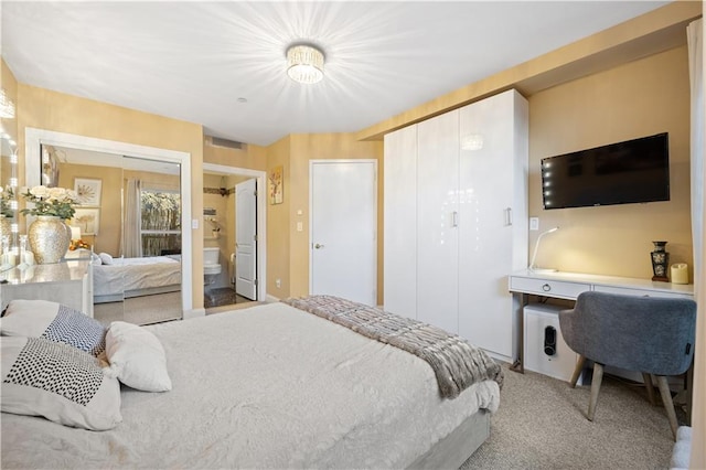 carpeted bedroom featuring visible vents and a closet