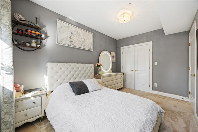 bedroom with carpet floors, a closet, and baseboards