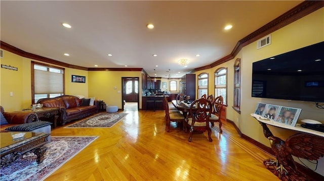 living room with recessed lighting, visible vents, crown molding, and baseboards