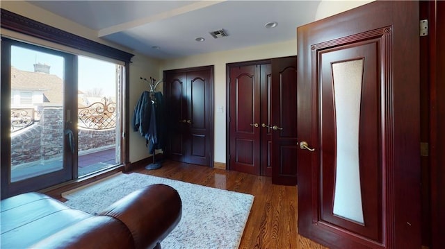 entrance foyer with baseboards, visible vents, and wood finished floors